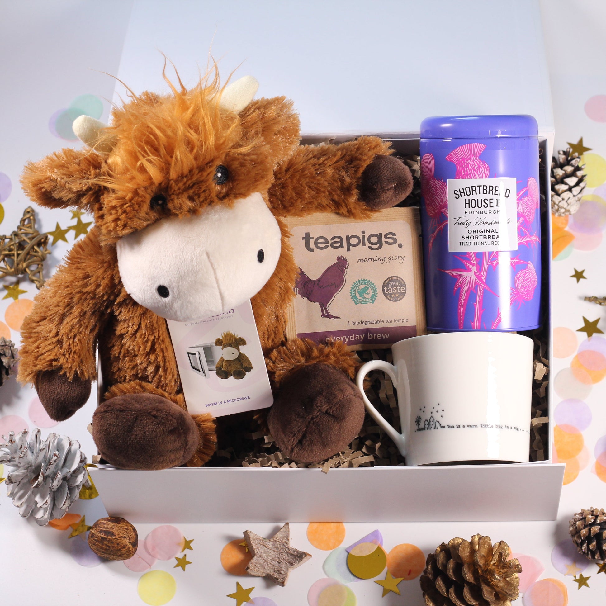 Gift box with Warmies heatable plush cow, hug mug, Edinburgh Shortbread house shortbread and and tea.