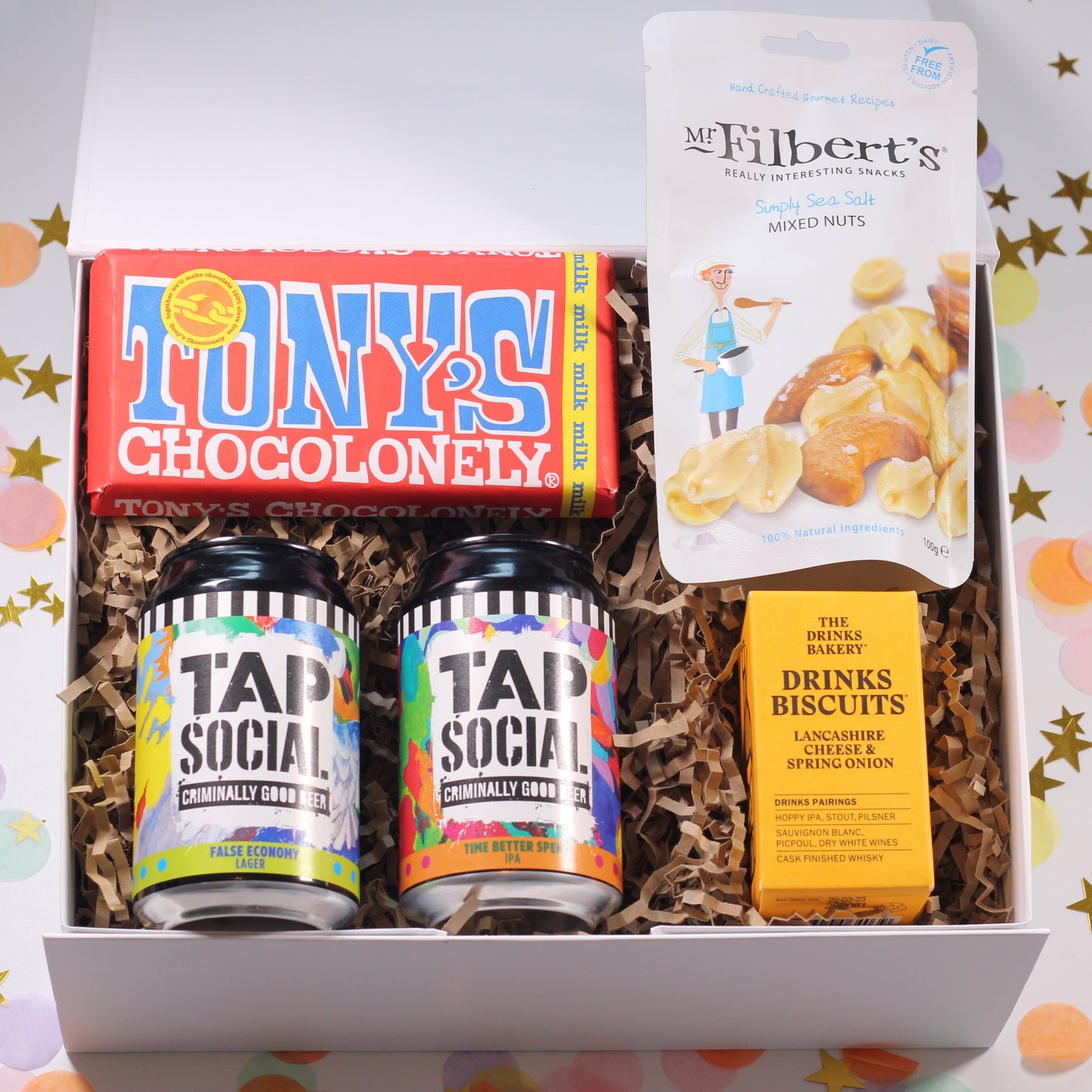 A gift box containing Tap Social Beers, snacks, and a Tonys chocolate bar on a colourful background.