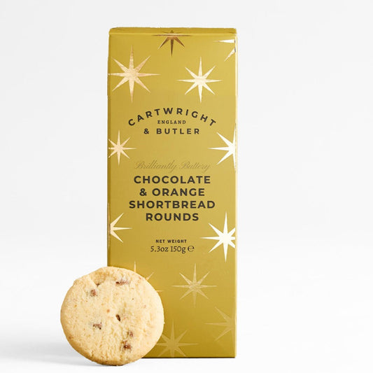 A single round chocolate chip shortbread cookie stands in front of a tall gold box labeled Cartwright & Butler Chocolate & Orange Shortbread Rounds, on a clean white background.