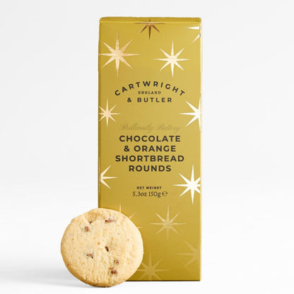 A single round chocolate chip shortbread cookie stands in front of a tall gold box labeled Cartwright & Butler Chocolate & Orange Shortbread Rounds, on a clean white background.