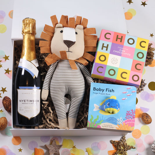 Gift box with champagne, lion plush toy, and children's book and box of chocolates