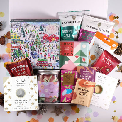 Christmas Gift hamper with Assorted festive food products, including sweets, festive chocolates, crisps, chocolate cherries, hot chocolate, shortbread, cocktails, popcorn and a festive jigsaw.