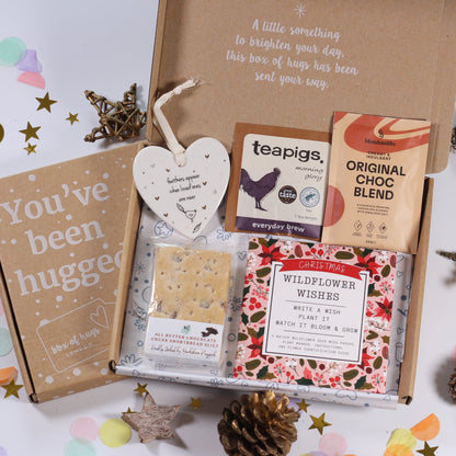 Letterbox gift box with tea, hot chocolate  cards, feathers appear heart ceramic plaque, chocolate chunk shortbread and wildflower wishes write a wish and plant it and let it grow.