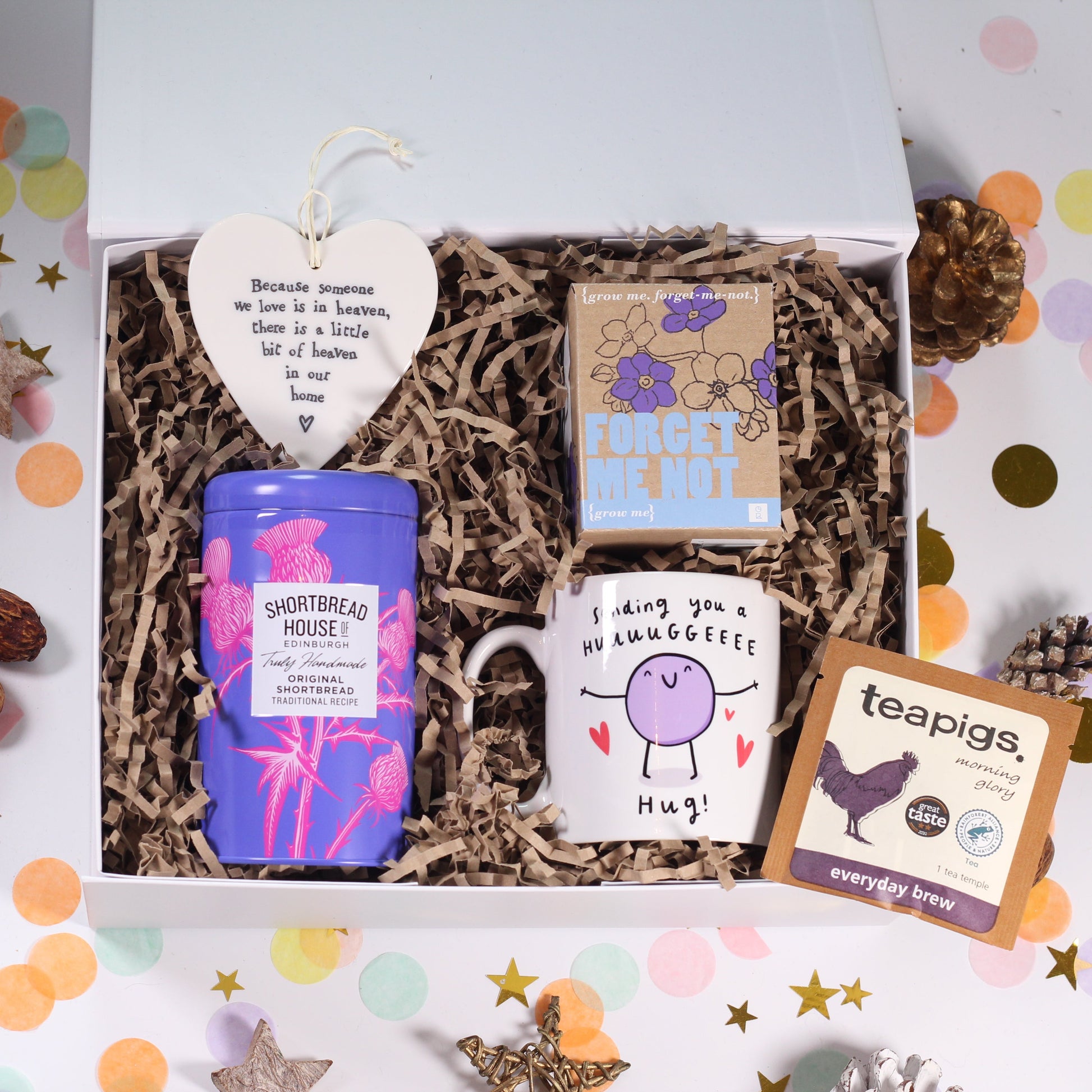 Bereavement Gift box with various items including a hug mug, tea, hanging heart sign with heaven quote forget me not seeds.