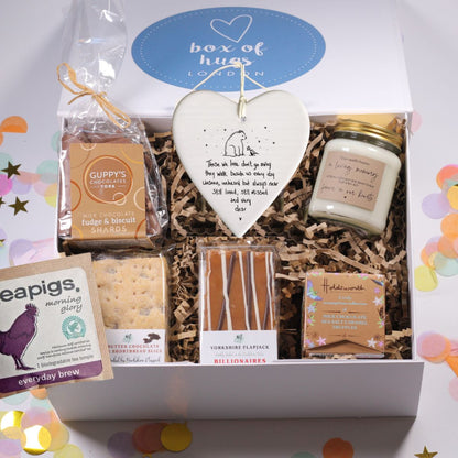 Gift box from Box of Hugs London with various items including a 'in loving memory candle' a heartfelt bereavement plaque and chocolates and flapjack and shortbread.