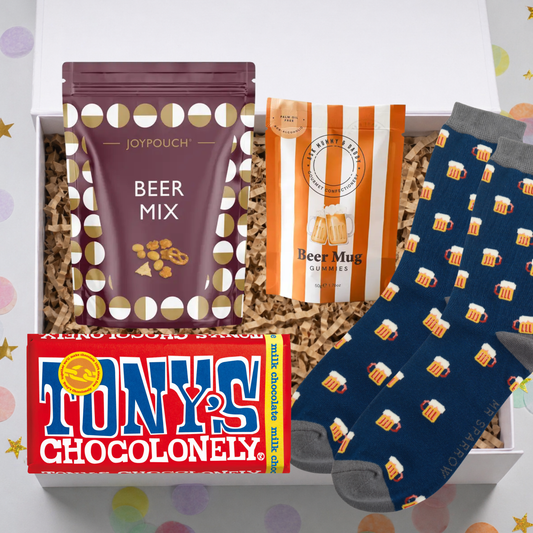 Gift set with beer-themed items including a bag of 'Beer Mix', a box of 'Tony's Chocolonely', and a pair of socks with beer mug designs.