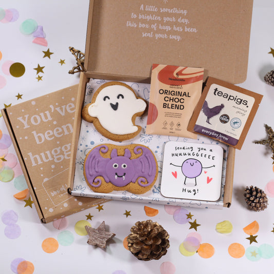 Halloween letterbox gift box with ghost and bat iced gingerbread biscuits, hot chocolate, tea and uplifting coaster.