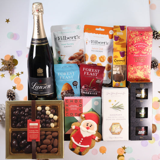 Christmas Gift hamper with champagne, chocolates, chocolate nuts, chocolate cherries, festive chutney, sea salted caramel biscuits, crackers and hot chocolate.