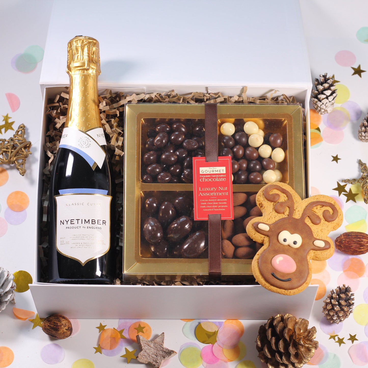 Christmas Gift Box with Nyetimber Sparkling Wine,  chocolate nuts, and a iced reindeer gingerbread biscuits.
