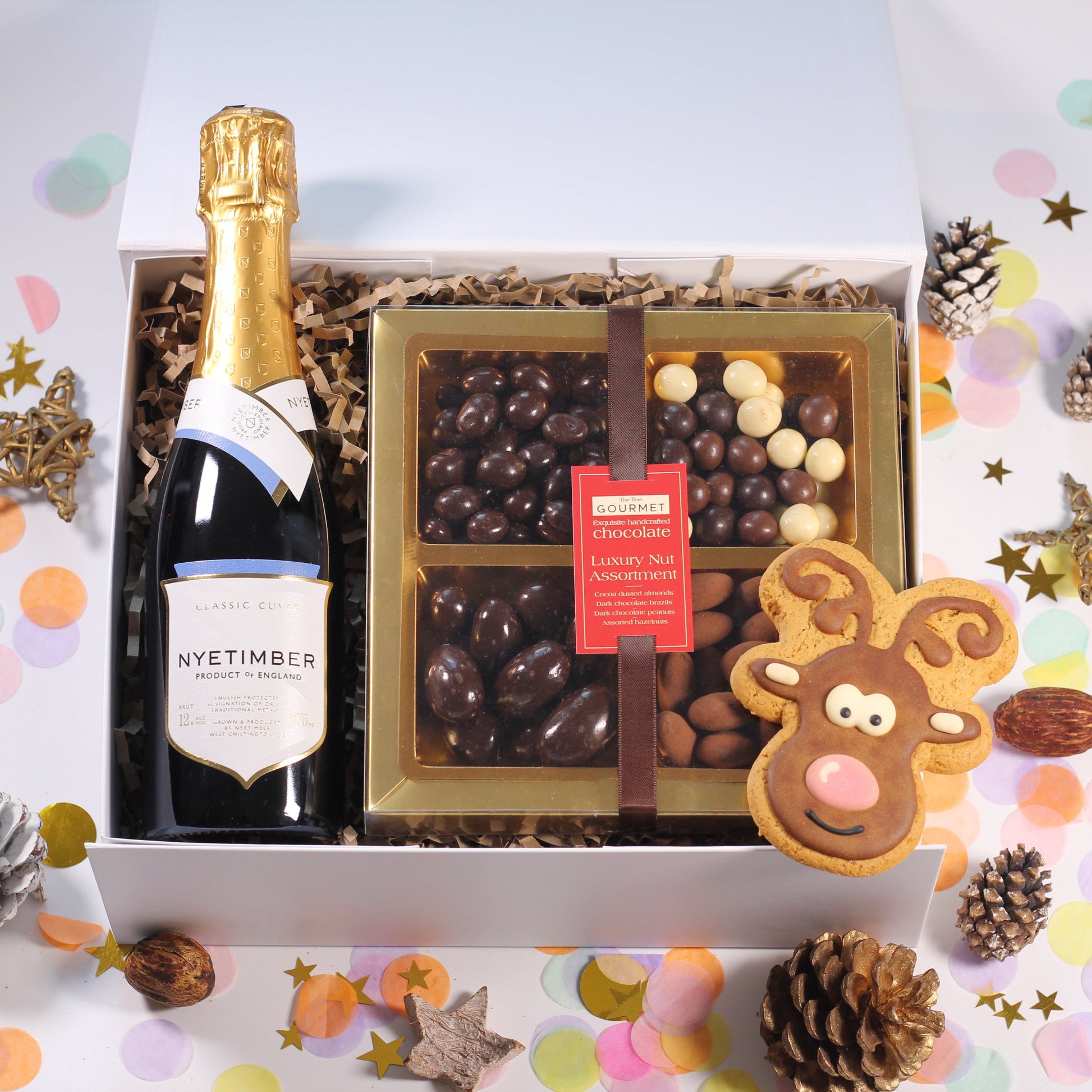 Christmas Gift Box with Nyetimber Sparkling Wine,  chocolate nuts, and a iced reindeer gingerbread biscuits.
