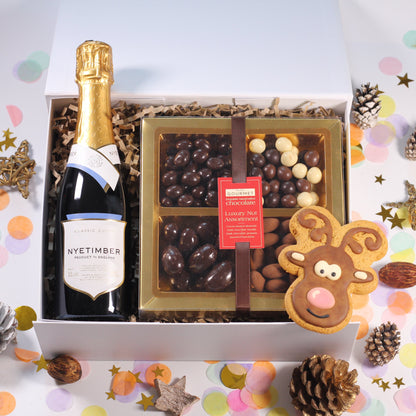 Christmas Gift Box with Nyetimber Sparkling Wine,  chocolate nuts, and a iced reindeer gingerbread biscuits.