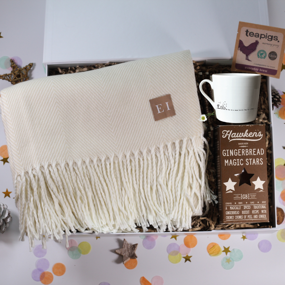 Cosy Gift box with a blanket, hug mug, and gingerbread stars and tea.