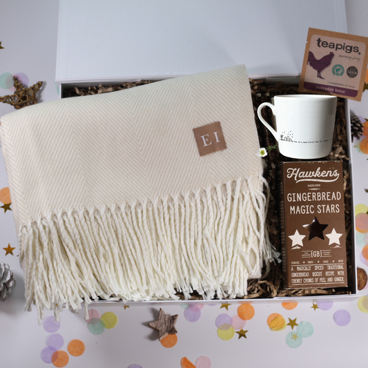 Cosy Gift box with a blanket, hug mug, and gingerbread stars and tea.