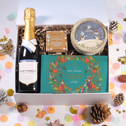 Christmas Gift box with Nyetimber, milk chocolate and salted caramel florentines, a box of chocolates, and a beautiful St Eval candle.
