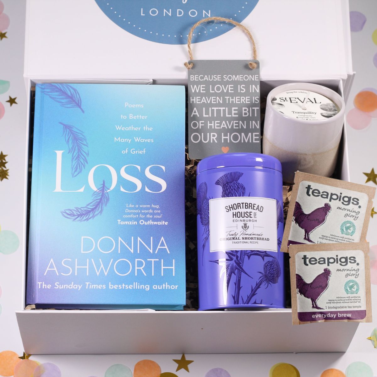 Gift set with a book titled 'Loss' by Donna Ashworth, a candle, and teapigs tea bags in a decorative box.
