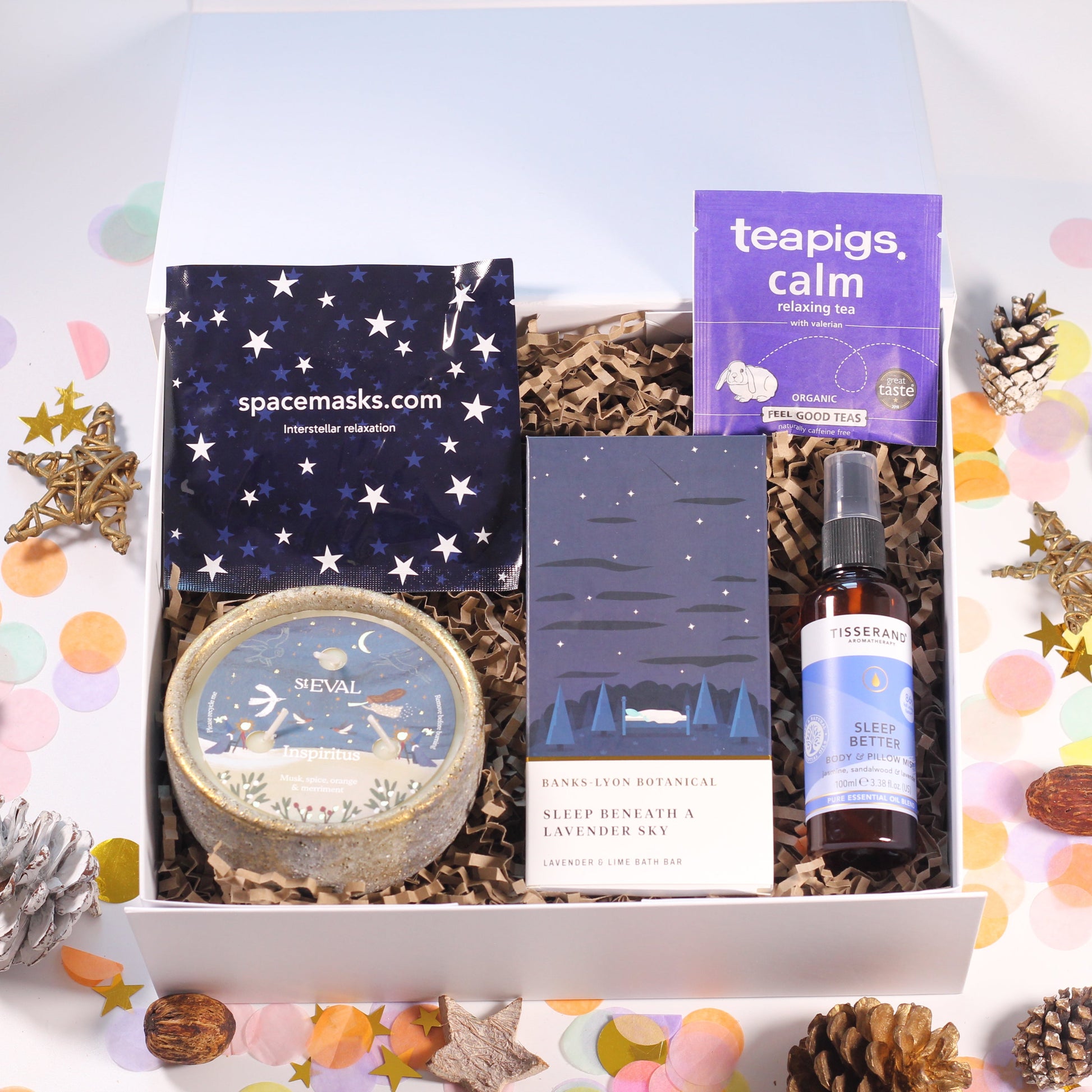 Gift box with spa items including a beautiful St Eval candle, lavender bath bar, tea and sleep better pillow spray.