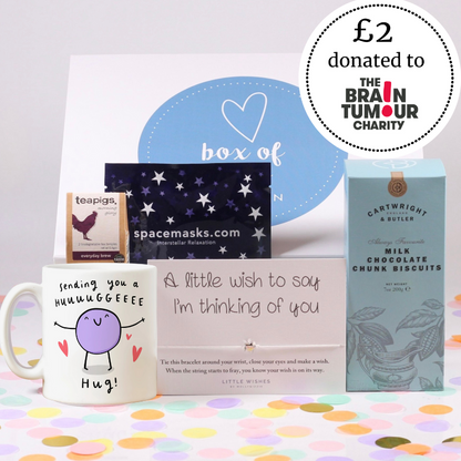 Collection of items including a mug, card, and chocolate box with a Brain Tumour Charity donation label.