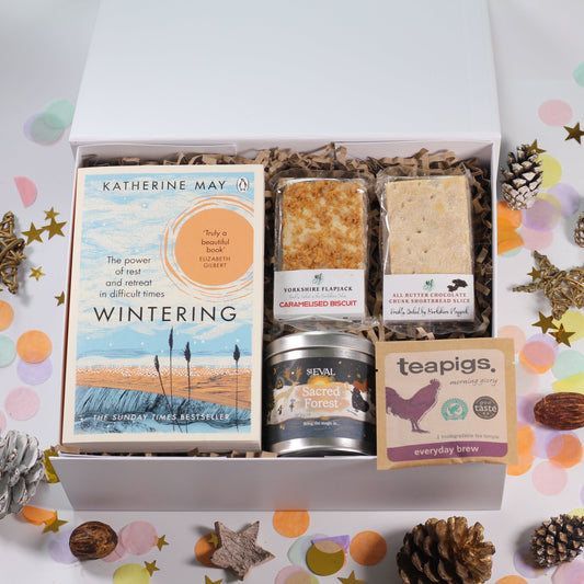 Gift box with 'Wintering' book, sweet snacks, St Eval sacred forest candle and tea. 