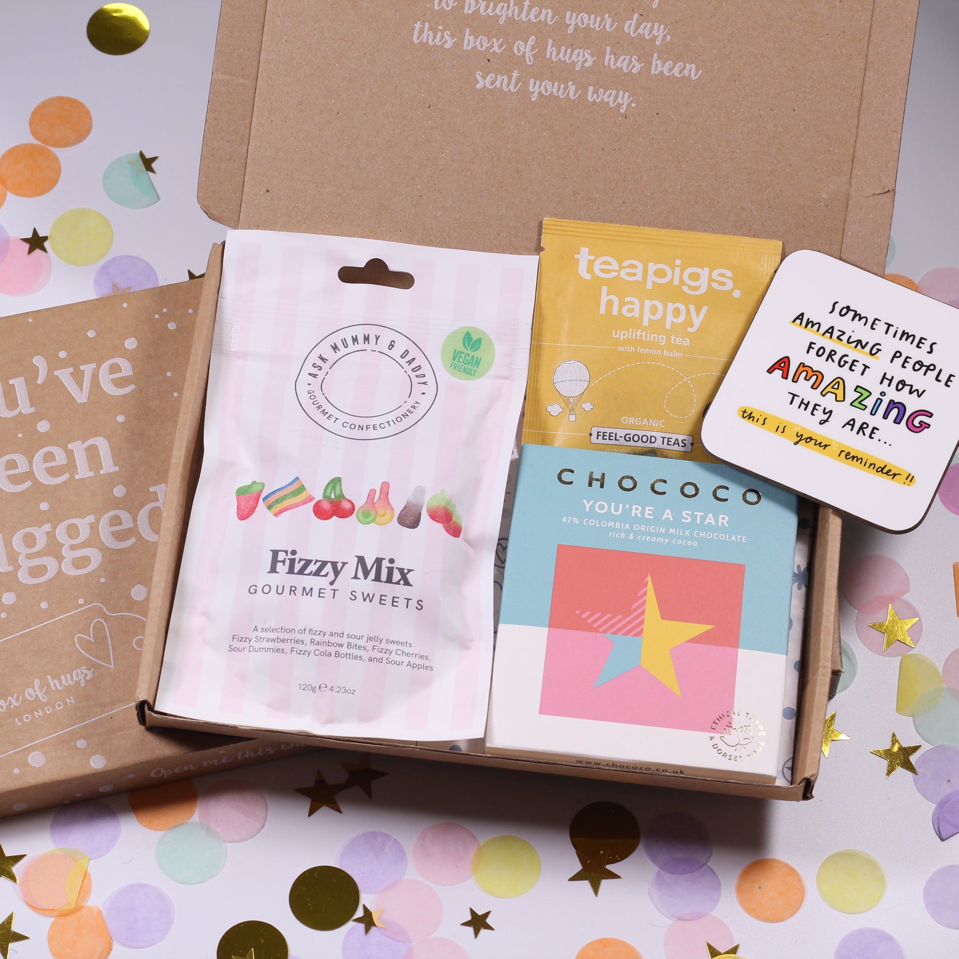 A Box of Hugs letterbox gift with you're a star chocolate, fizzy mix gourmet sweets, uplifting coaster and happy tea.