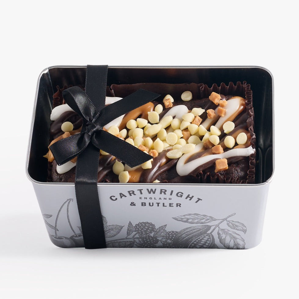 Chocolate tray with a black bow and visible brand name on a white background